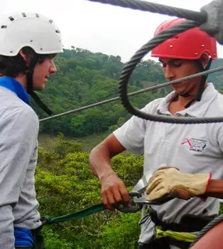 Putting on your harness for canopy tours Putting on your harness for canopy tours