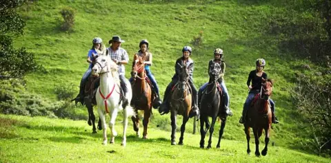Horseback Riding Group on Mountain Farmland