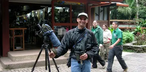Bird guide with a spotting scope outside the souvenir shop at the Monteverde Cloud Forest Reserve