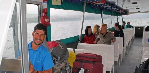 Passengers with Luggage on Taxi Boat Taxi